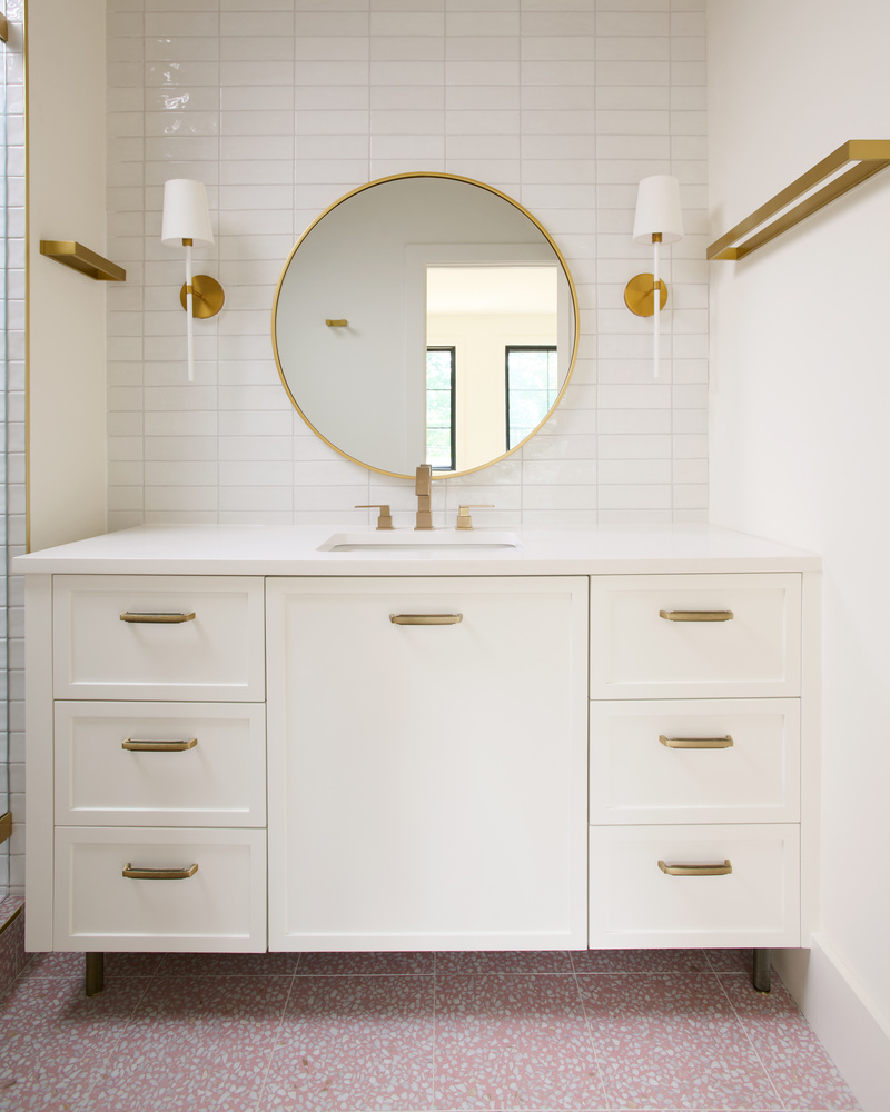 Contemporary bathroom vanity by DesignLab in a Vienna, VA custom home with round mirror and gold fixtures