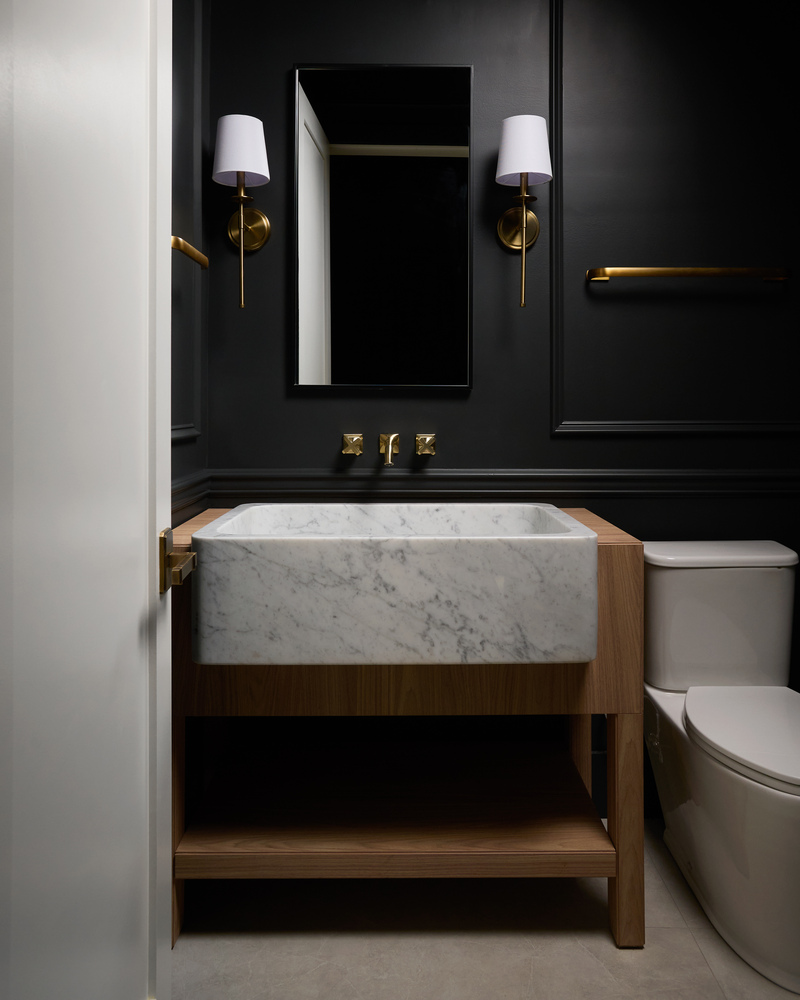 Dark and elegant powder room with marble sink and gold fixtures by DesignLab in Georgetown, DC