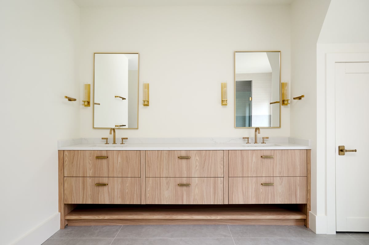 Floating wood vanity with double sinks and brass mirrors by DesignLab in a custom home in AU Park, DC