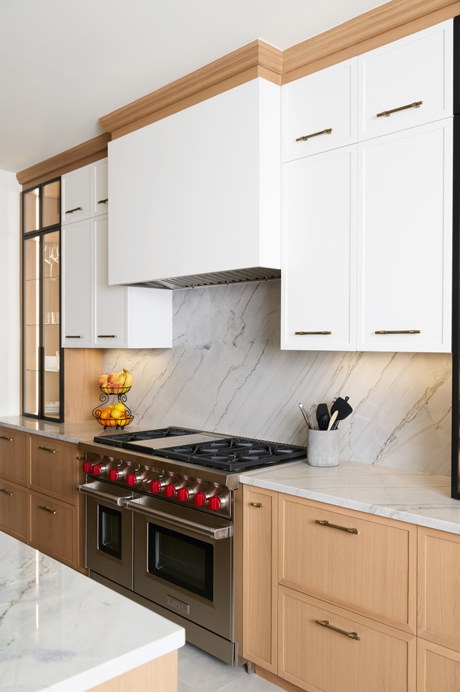 Luxury cooking area with marble slab backsplash and wood cabinets in a custom home by DesignLab in AU Park, DC