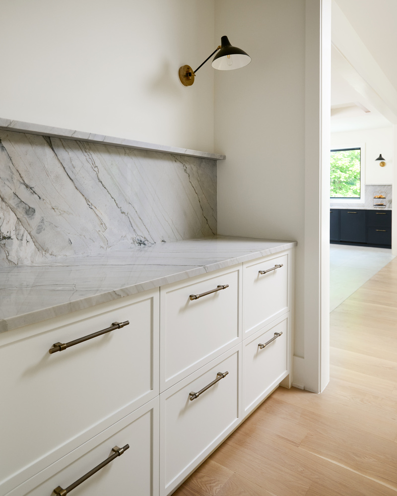 Marble backsplash and white cabinetry in scullery area of a DesignLab custom home in Cabin John, MD