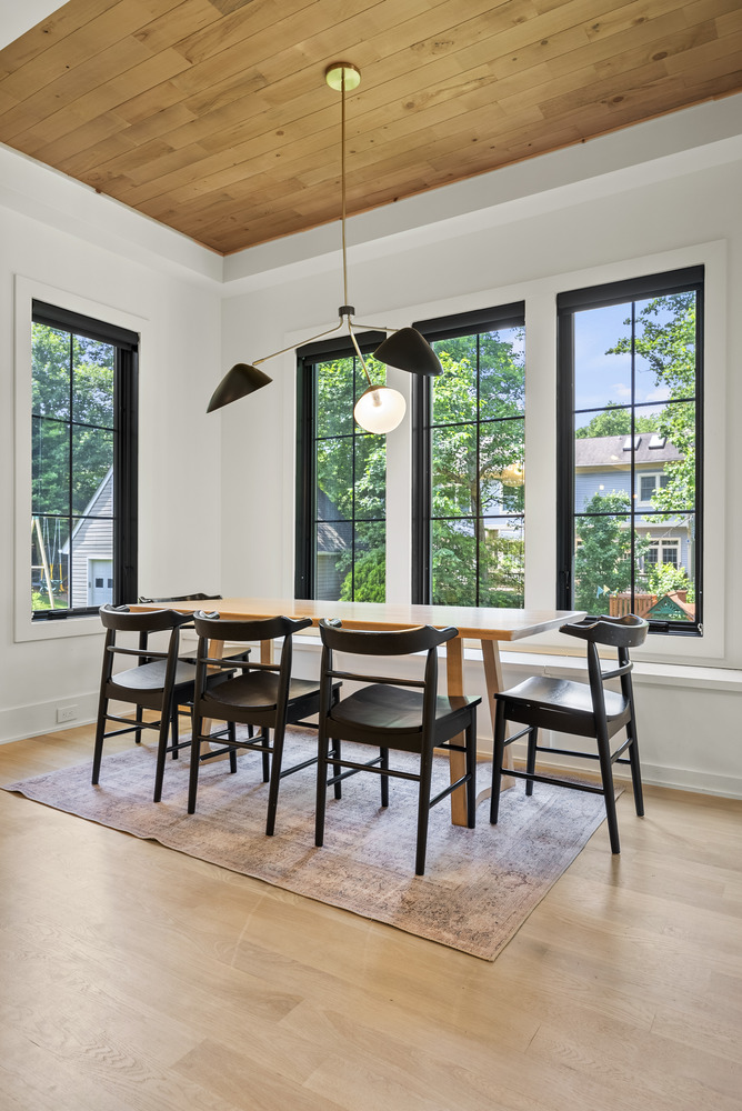 Bright breakfast nook with modern lighting in a Washington, DC custom home by DesignLab