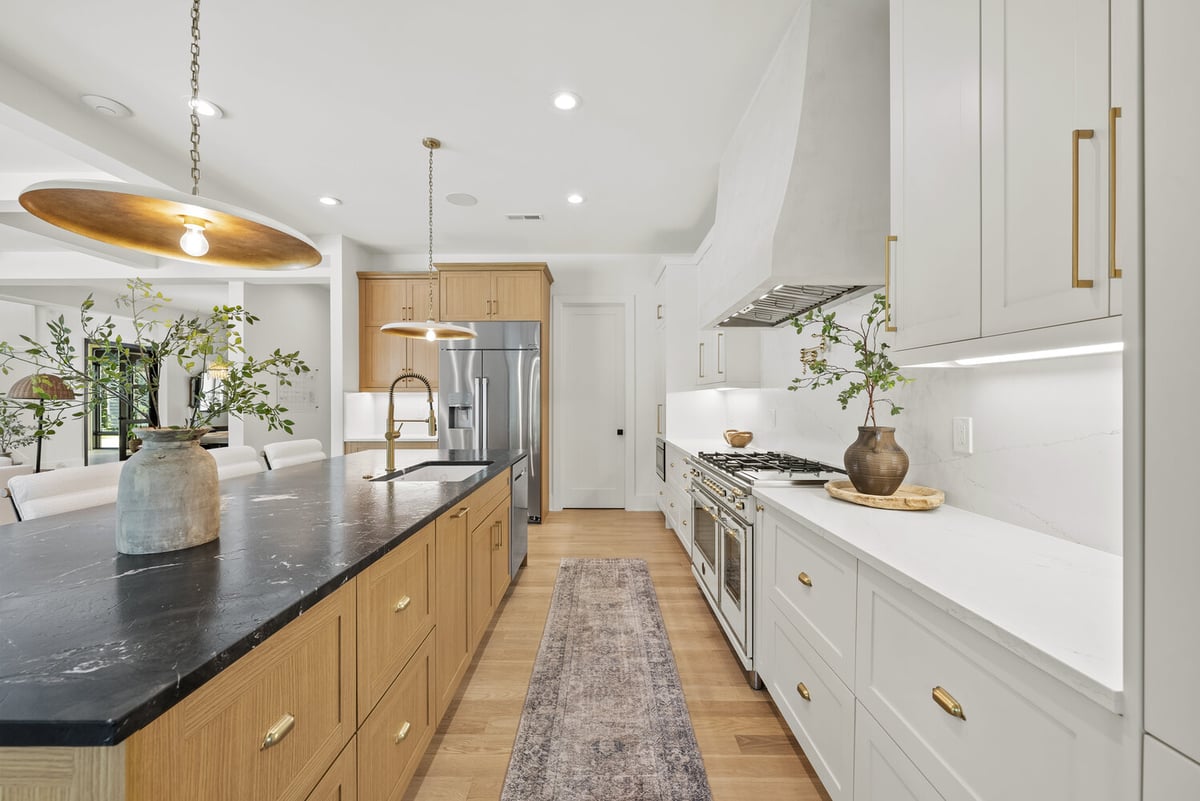 Sleek kitchen design with black countertops by DesignLab in Washington, DC