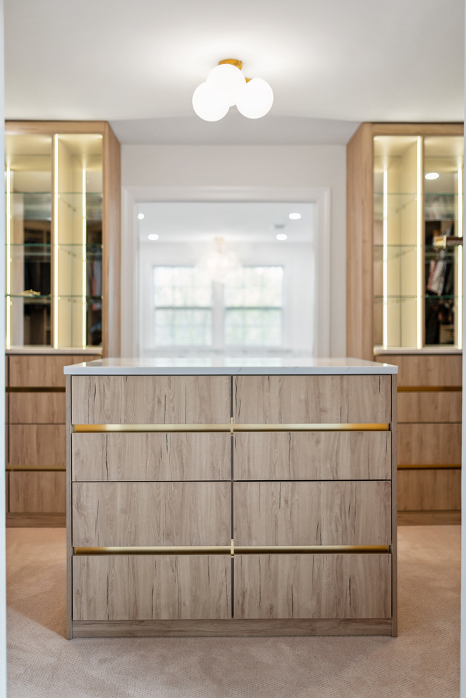 Central island detail of modern walk-in closet renovation by DesignLab in Metro Washington