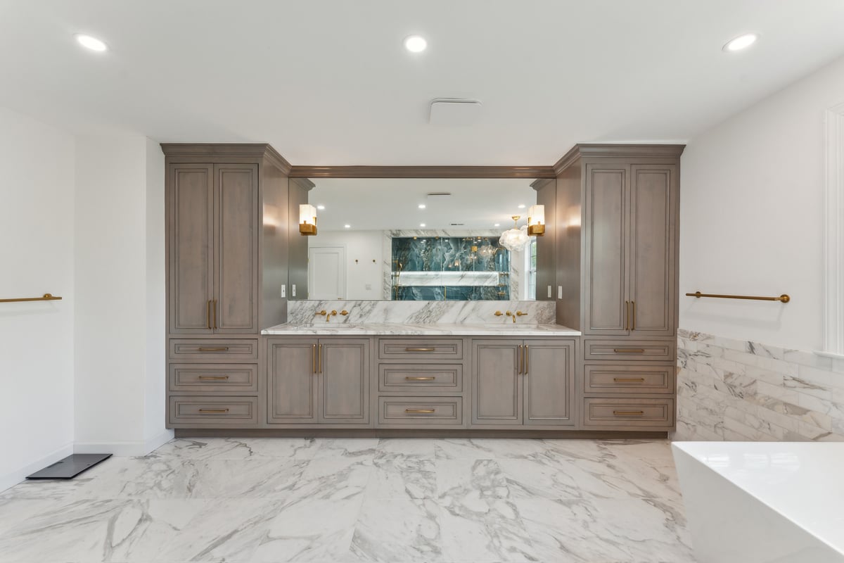 Custom double vanity with tall cabinets and gold fixtures in Metro Washington by DesignLab