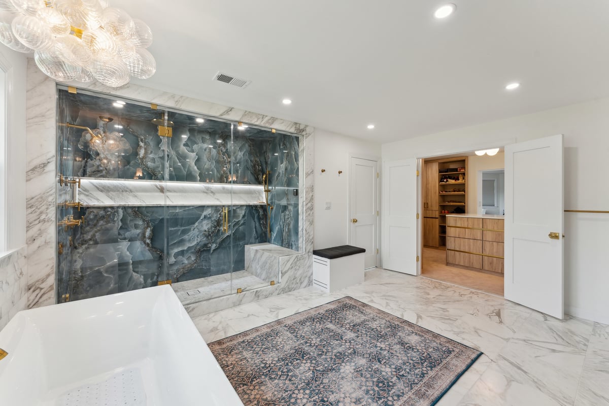Ensuite bathroom with walk-in shower and marble floors in DC Metro