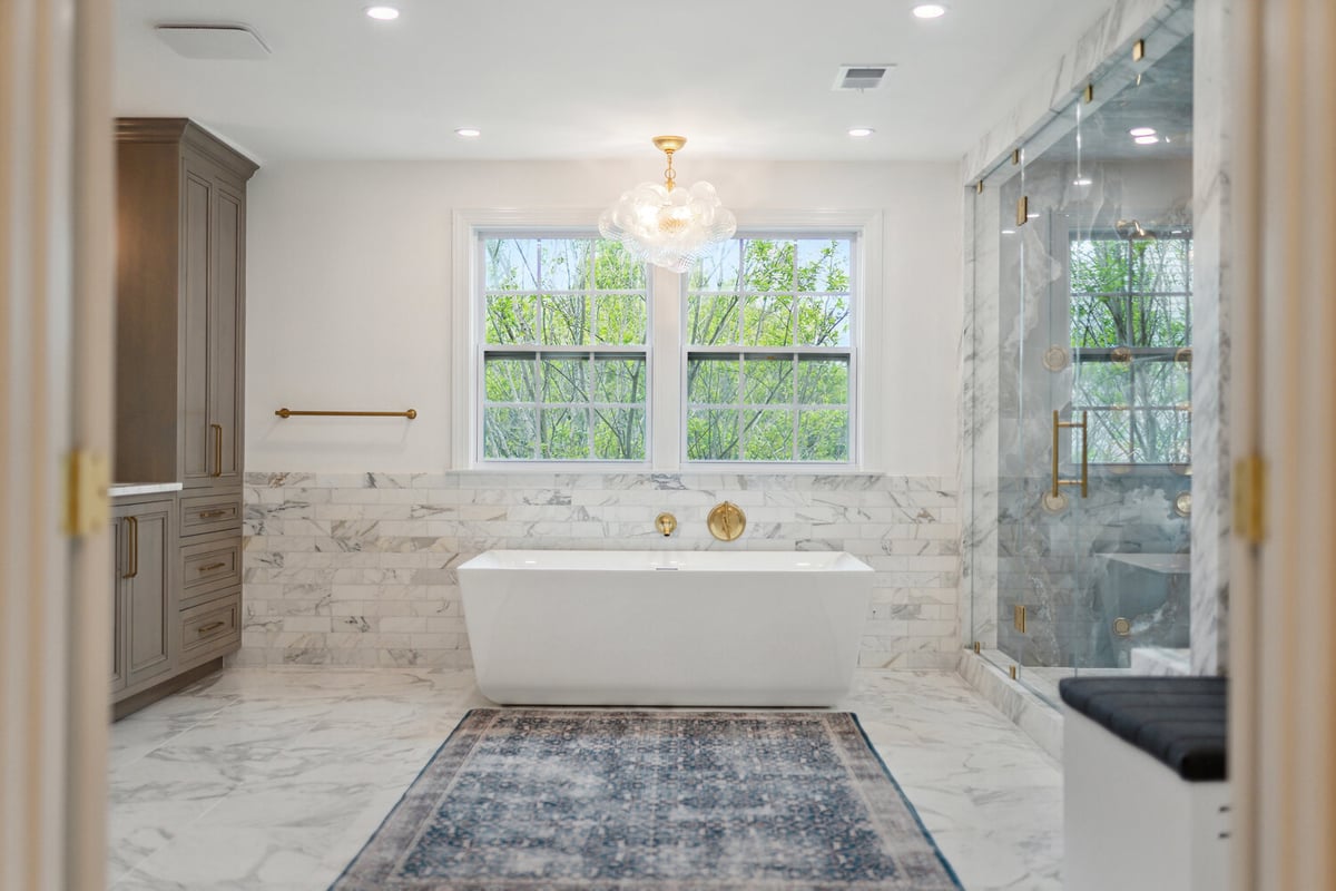 Freestanding tub and marble shower in luxury bathroom renovation by DesignLab in Metro Washington