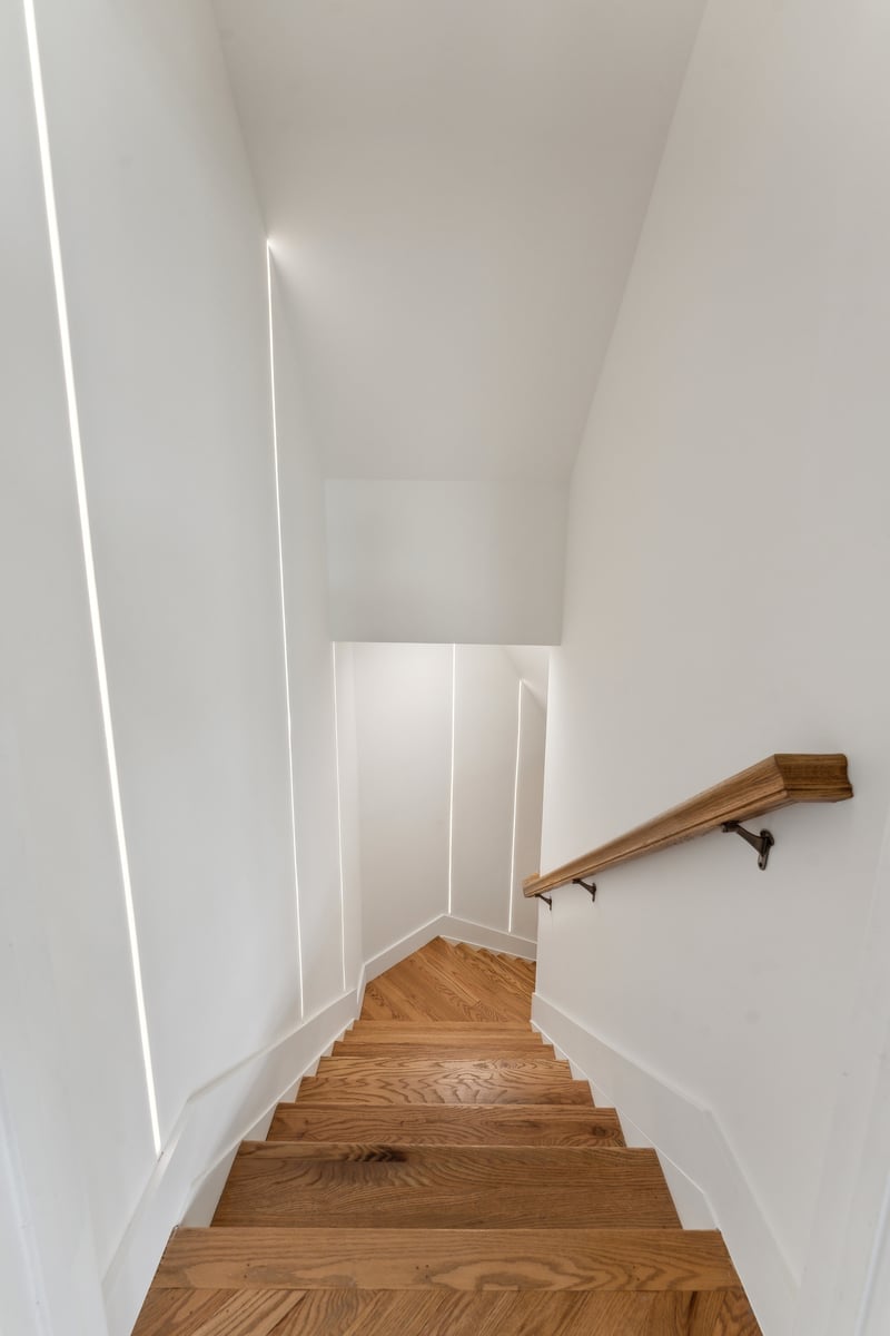 Remodeled home stairway with wood paneling on walls and dark wood floors in Metro DC