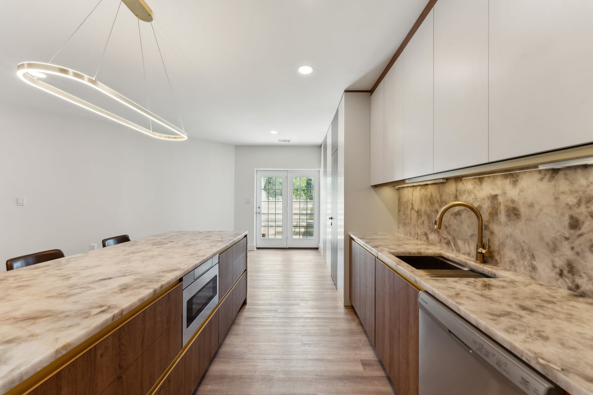 Remodeled kitchen in Metro DC with sleek dark wood lower cabinets and white upper cabinets