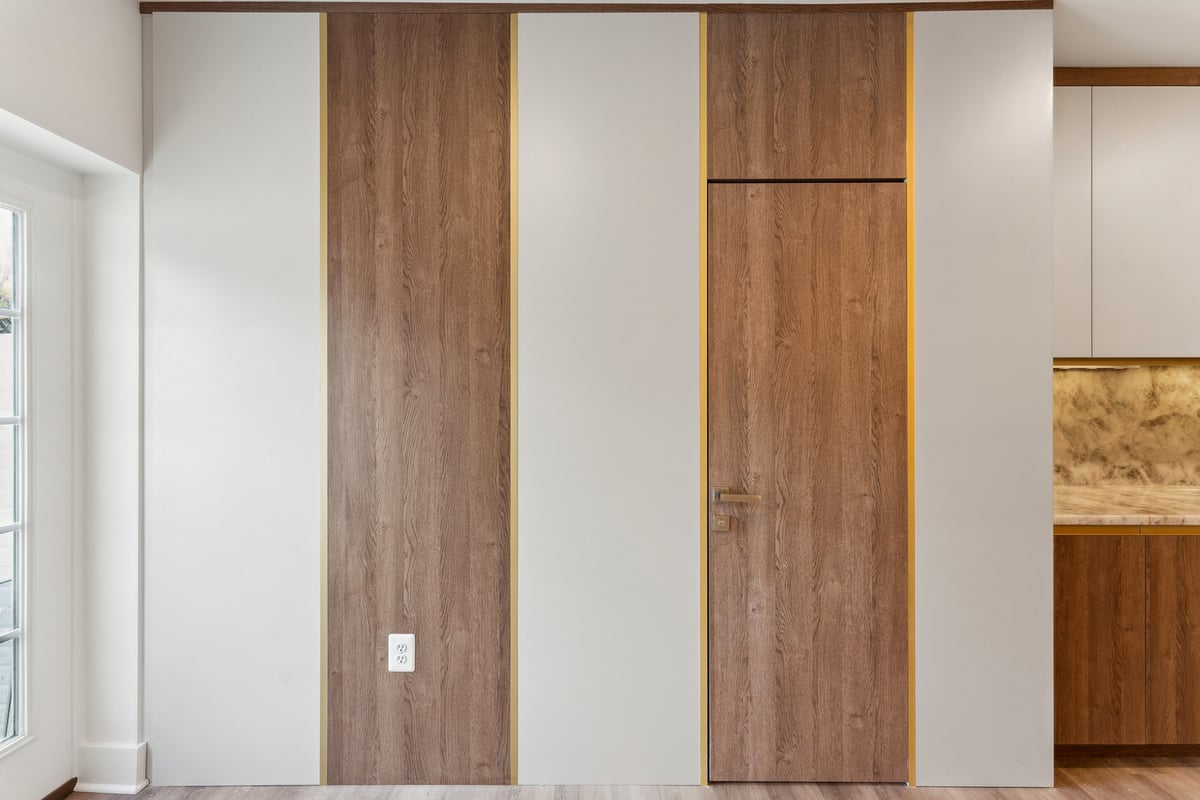 Wood paneled wall with hidden door in a remodeled DC Metro home
