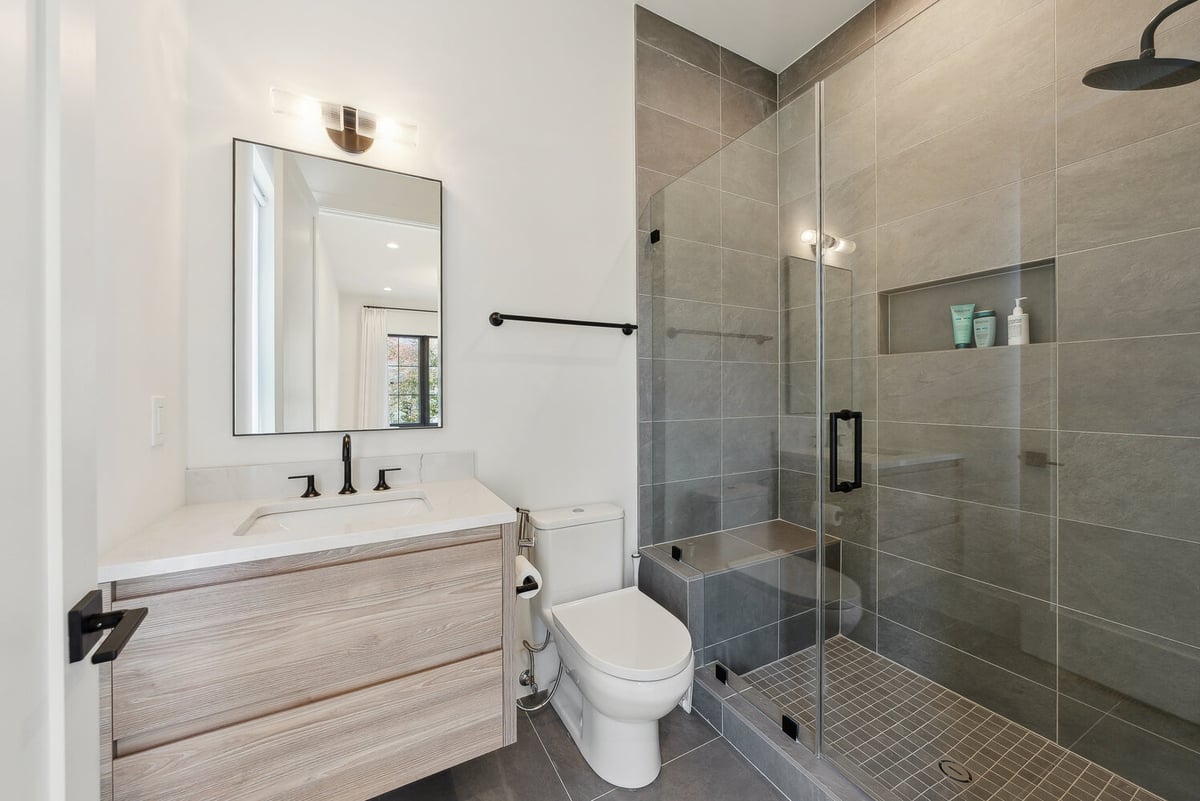 Contemporary bathroom with large tile shower in a Washington, DC home by DesignLab