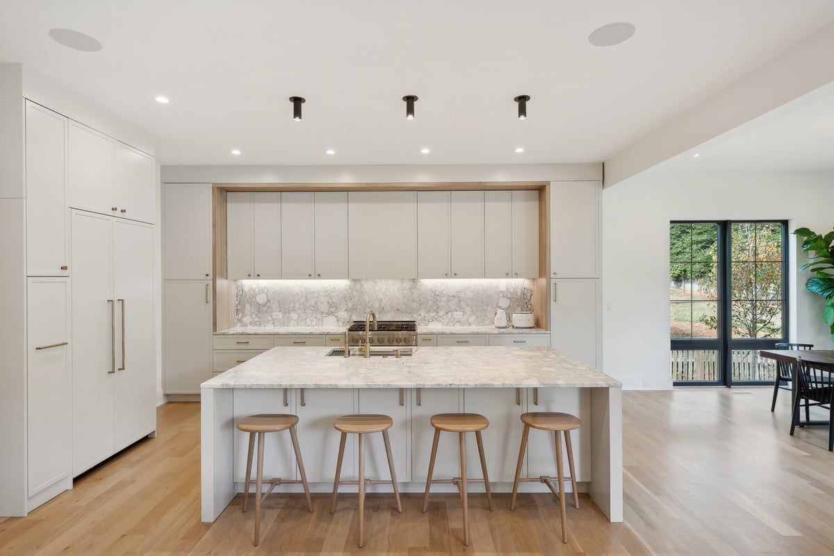 Expansive kitchen layout featuring waterfall island and custom lighting by DesignLab in Capitol Hill, DC