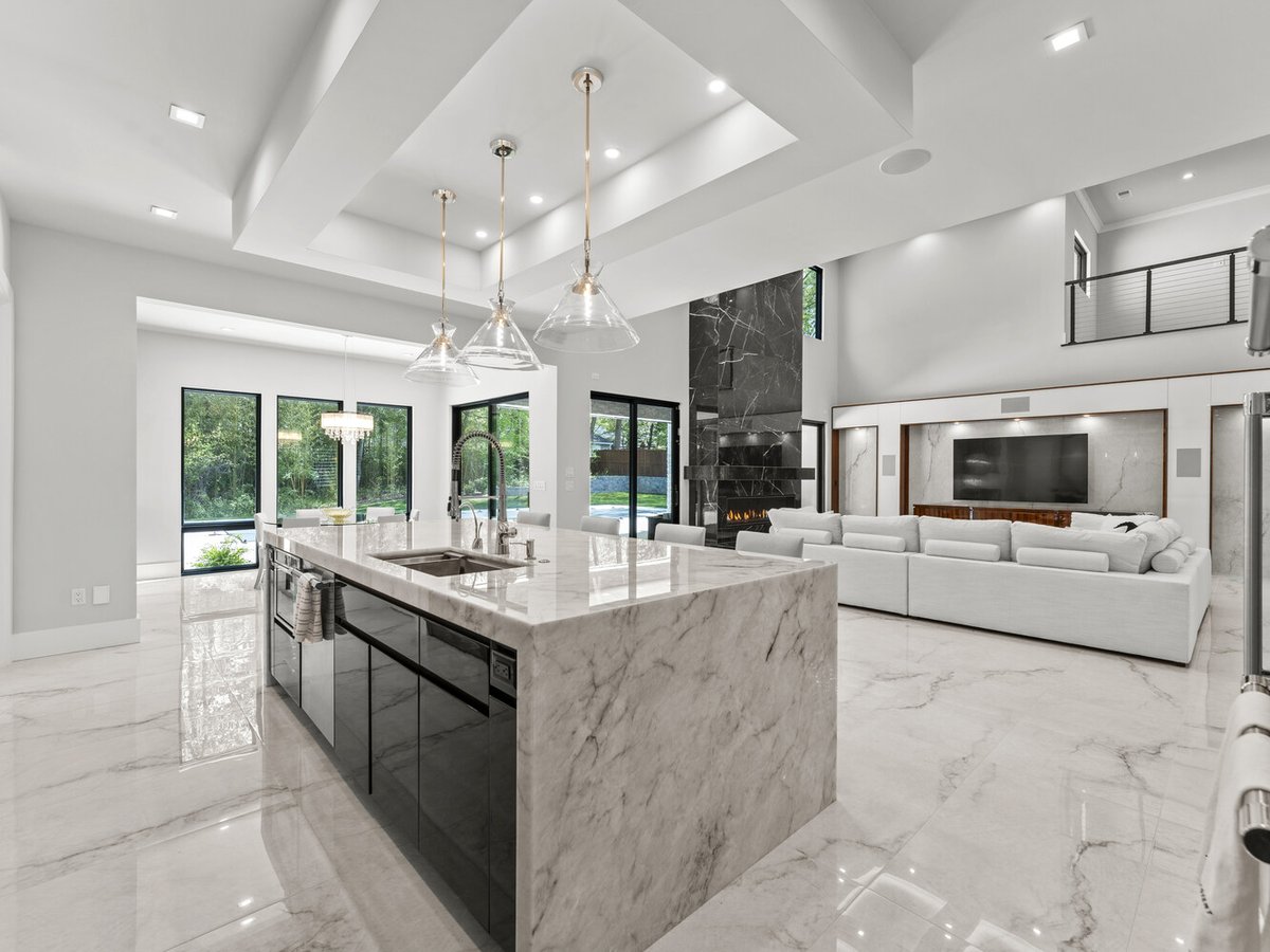Contemporary kitchen and living space with fireplace and island seating in a DesignLab custom home in Washington, DC