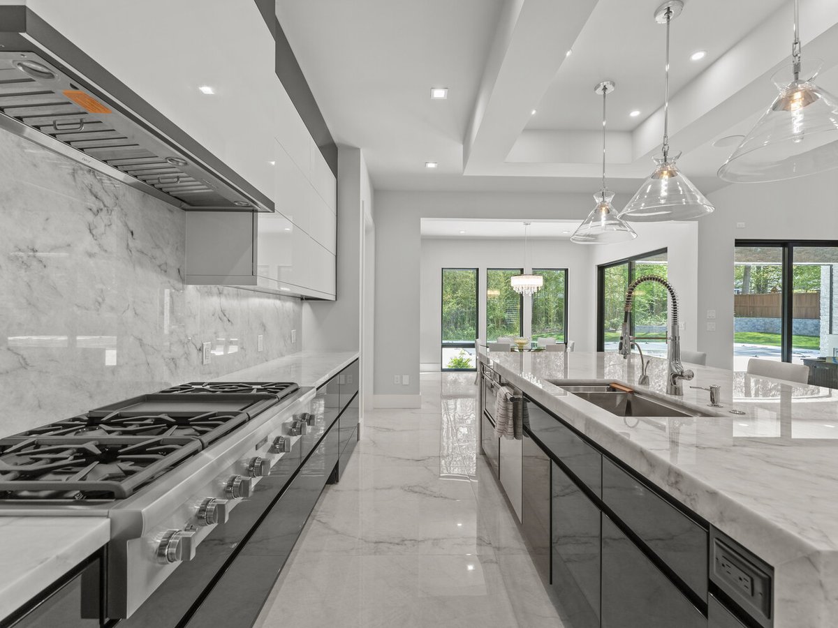 Designer kitchen with glass pendant lighting and garden views in a custom DesignLab home in Falls Church, VA