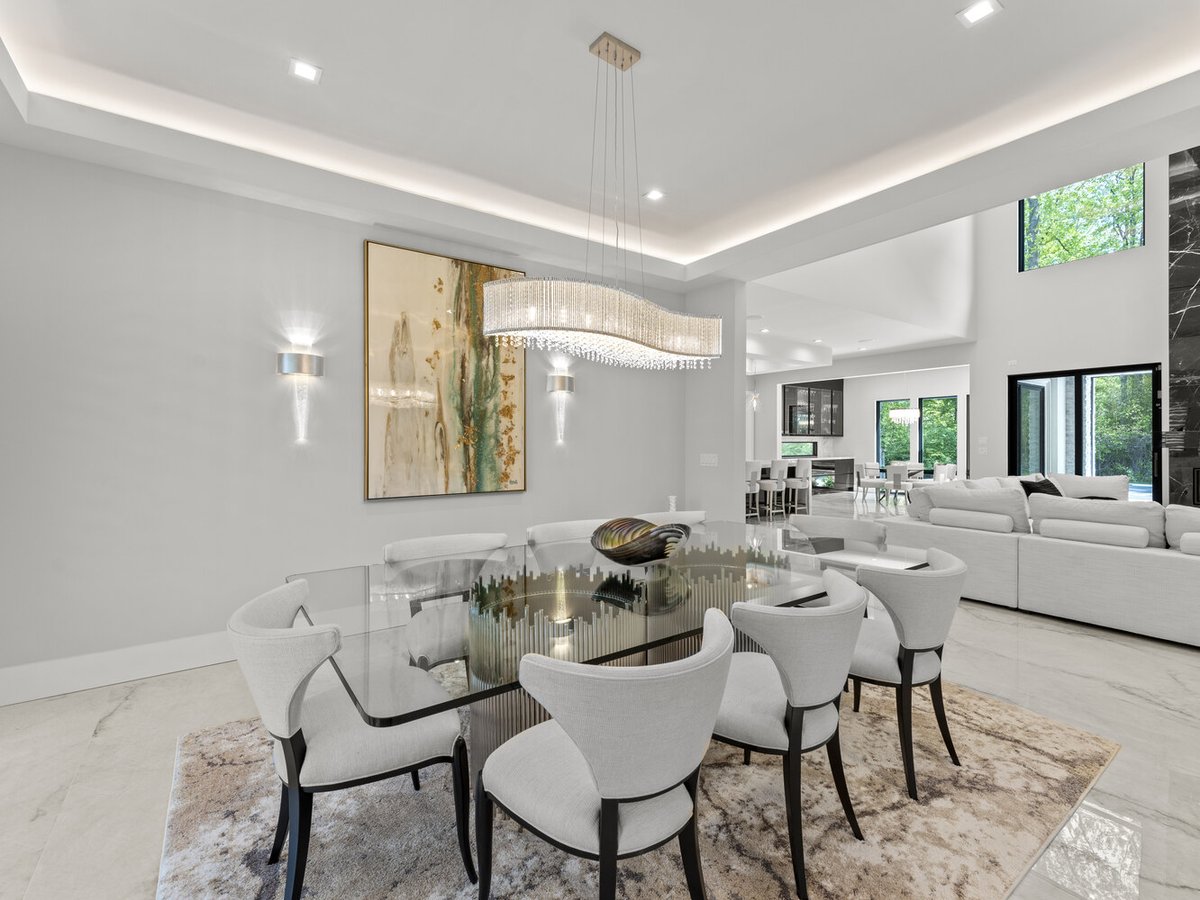 Elegant dining room with chandelier and glass table by DesignLab in Northern Virginia home project
