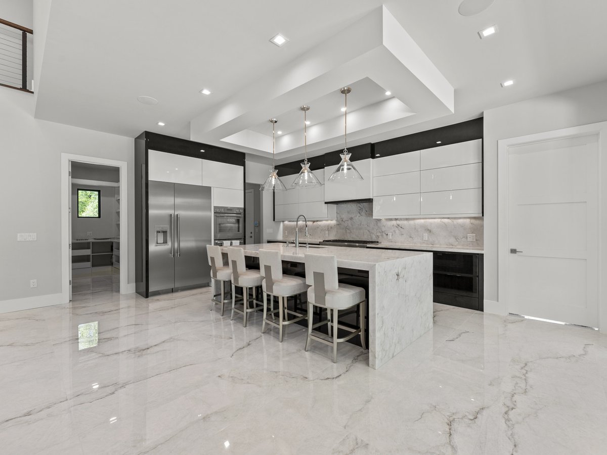 Elegant kitchen with oversized island and white cabinetry by DesignLab in Northern Virginia