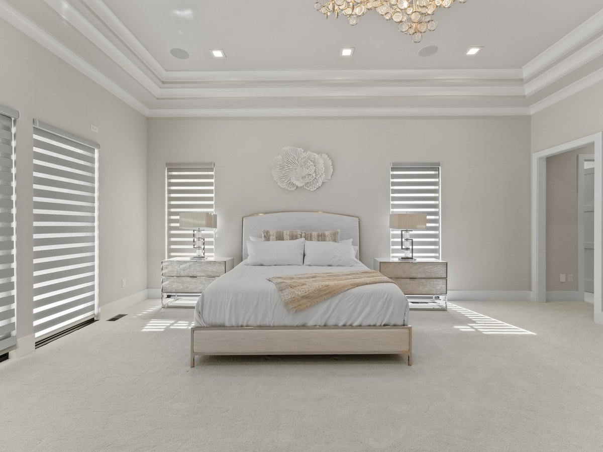 Elegant master bedroom with tray ceiling and custom window shades by DesignLab in Northern Virginia
