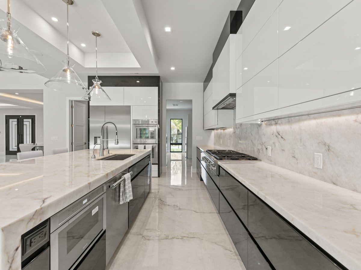 Gourmet kitchen layout with high-gloss cabinetry and island seating in a DesignLab custom home in Georgetown, DC