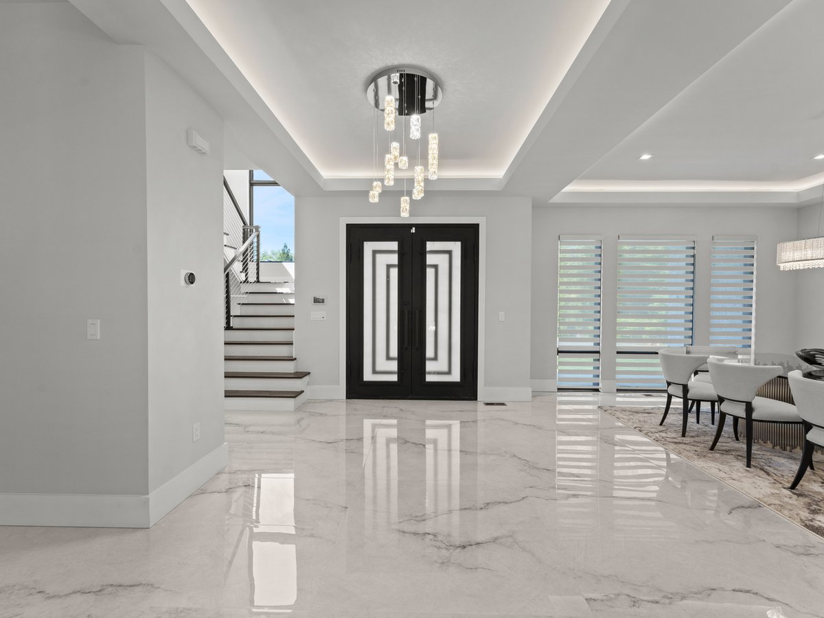 Grand entryway with chandelier and black double doors in a DesignLab custom home in Washington, DC