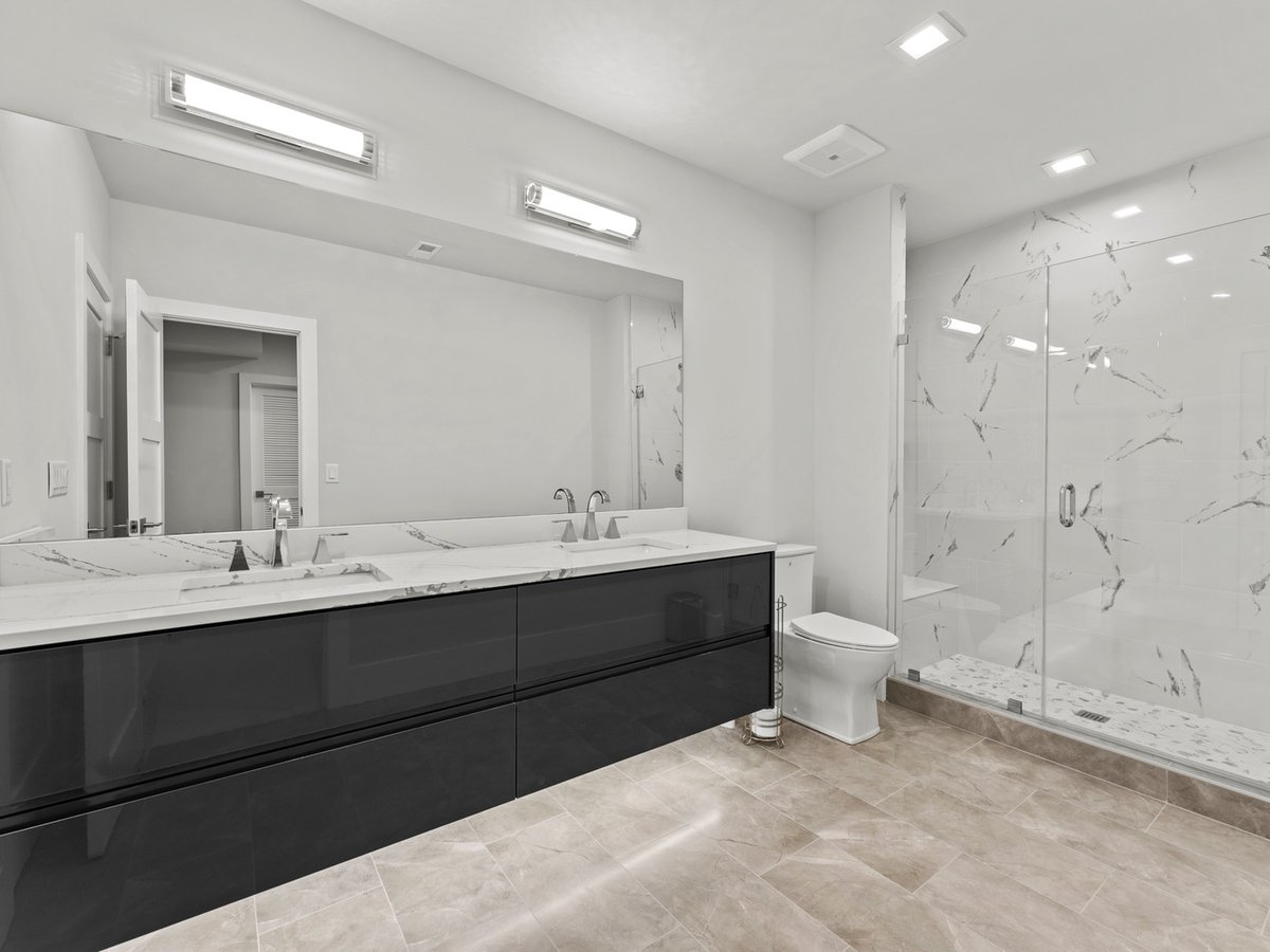 Guest bathroom with marble shower and modern double vanity by DesignLab in Northern Virginia