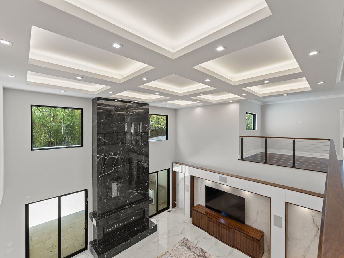 Luxury living room with modern ceiling and black marble fireplace by DesignLab in Northern Virginia