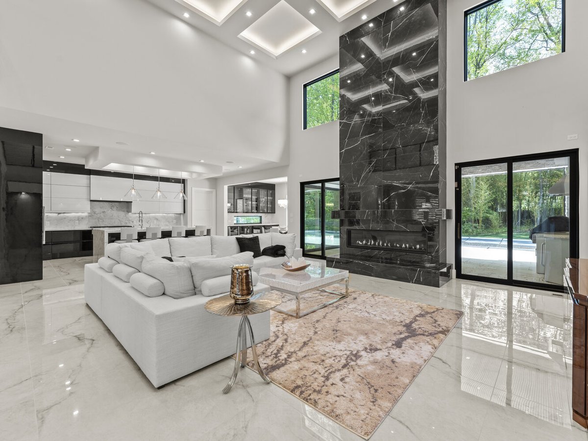 Natural light-filled great room with floor-to-ceiling windows by DesignLab in Bethesda, MD