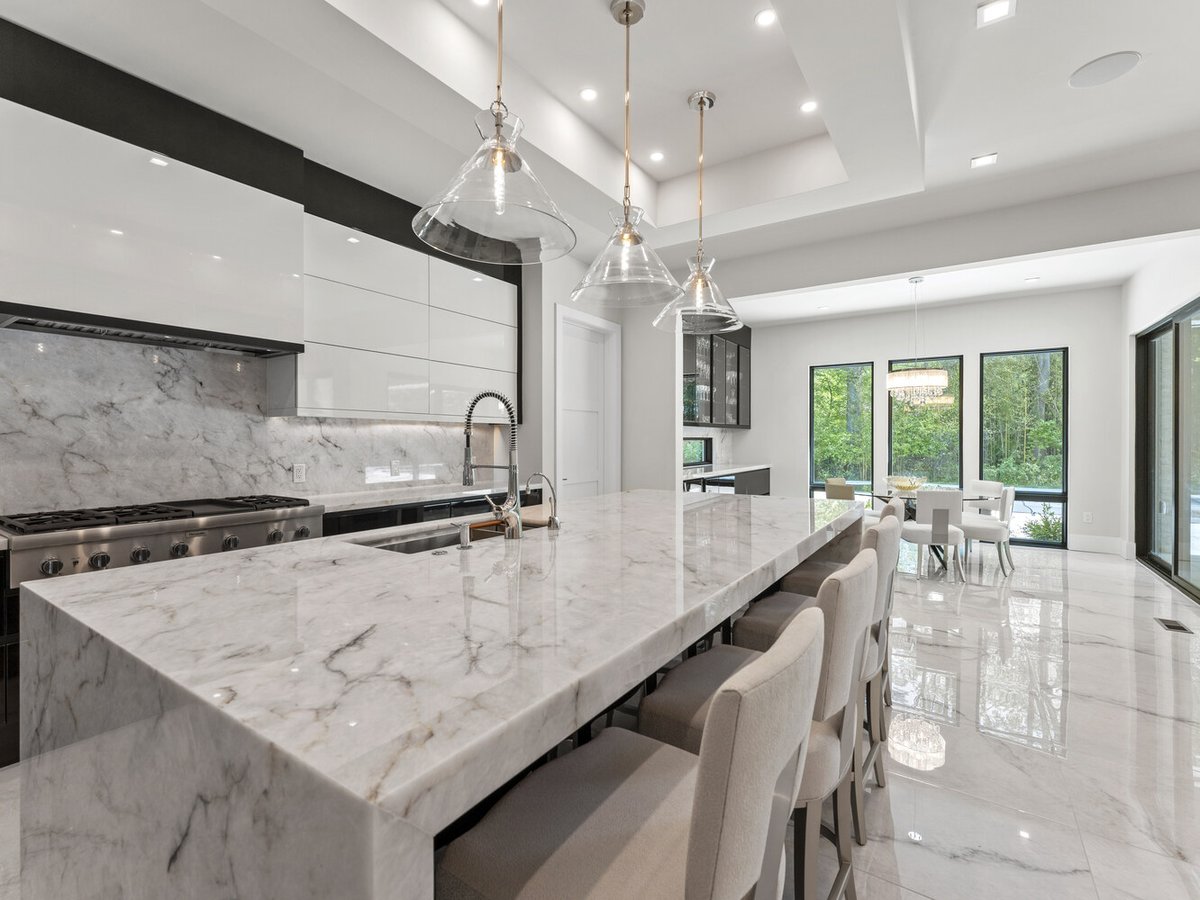 Open-plan kitchen with glass accents and luxury stone finishes in a DesignLab home in Kalorama, DC