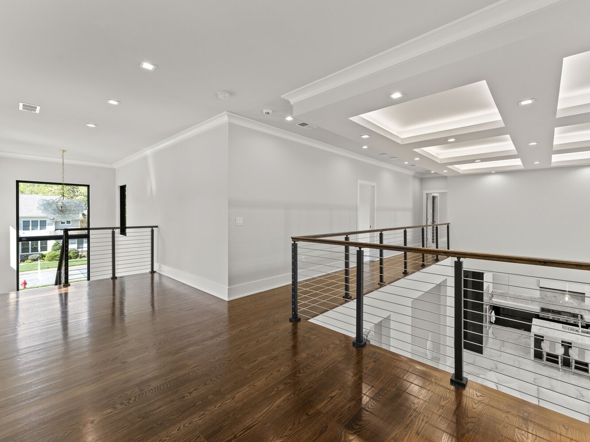 Second-floor hallway with open railing and coffered ceilings in a DesignLab custom home in Falls Church, VA