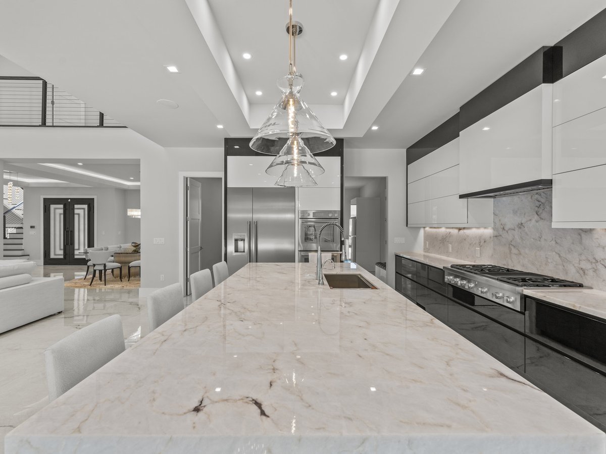 Spacious island kitchen with contemporary lighting in a custom home by DesignLab in Vienna, VA