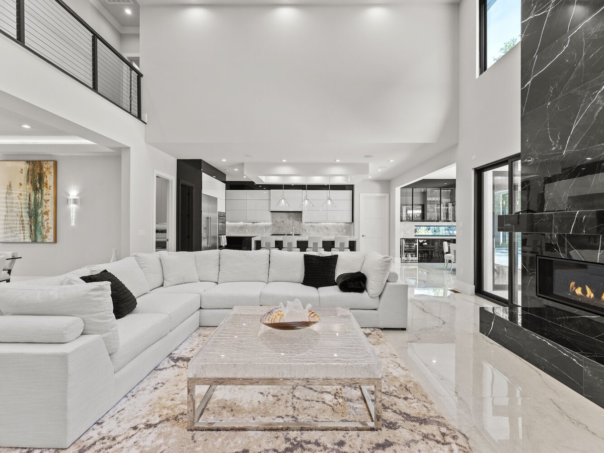 View into modern kitchen and living area with marble flooring in a DesignLab custom home in Arlington, VA