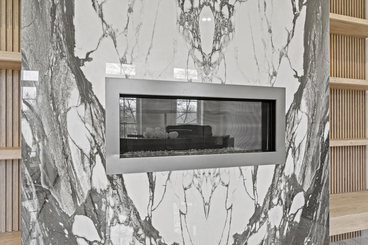Close-up of book-matched marble fireplace surround in a Northern Virginia whole home remodel by designlab