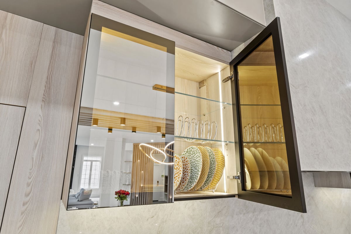 Illuminated kitchen cabinet interior design with elegant dish storage by DesignLab in a Metro Washington home
