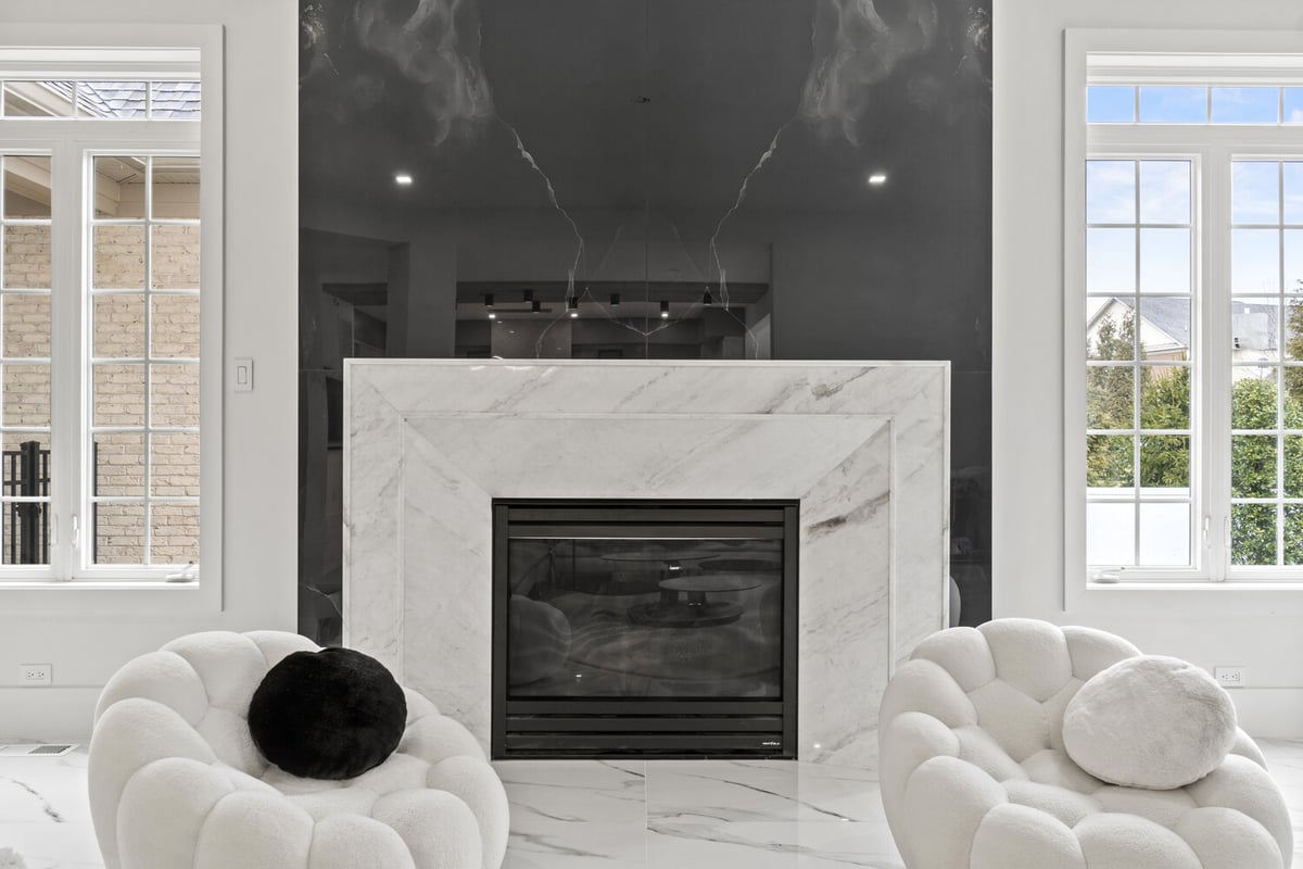 Living room fireplace wall with contrasting black and white stone by DesignLab in Metro Washington