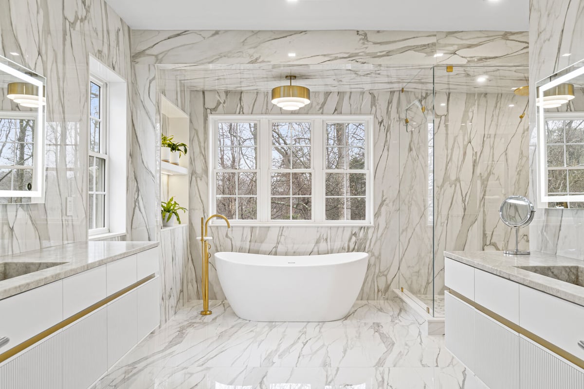 Luxury bathroom with freestanding tub and floor-to-ceiling marble in a whole home remodel by designlab, Northern Virginia