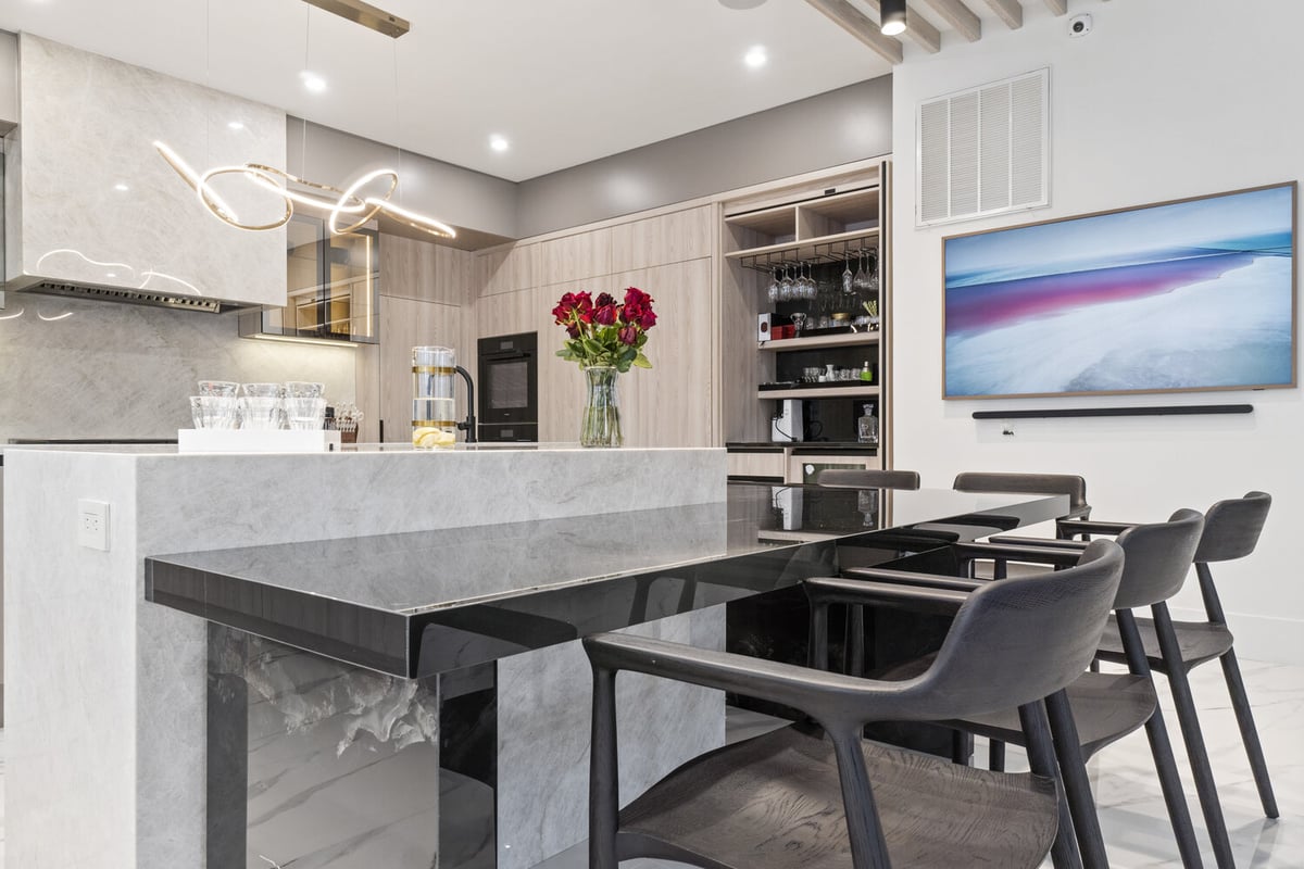 Open kitchen view featuring waterfall island and built-in bar in Northern Virginia remodel by designlab