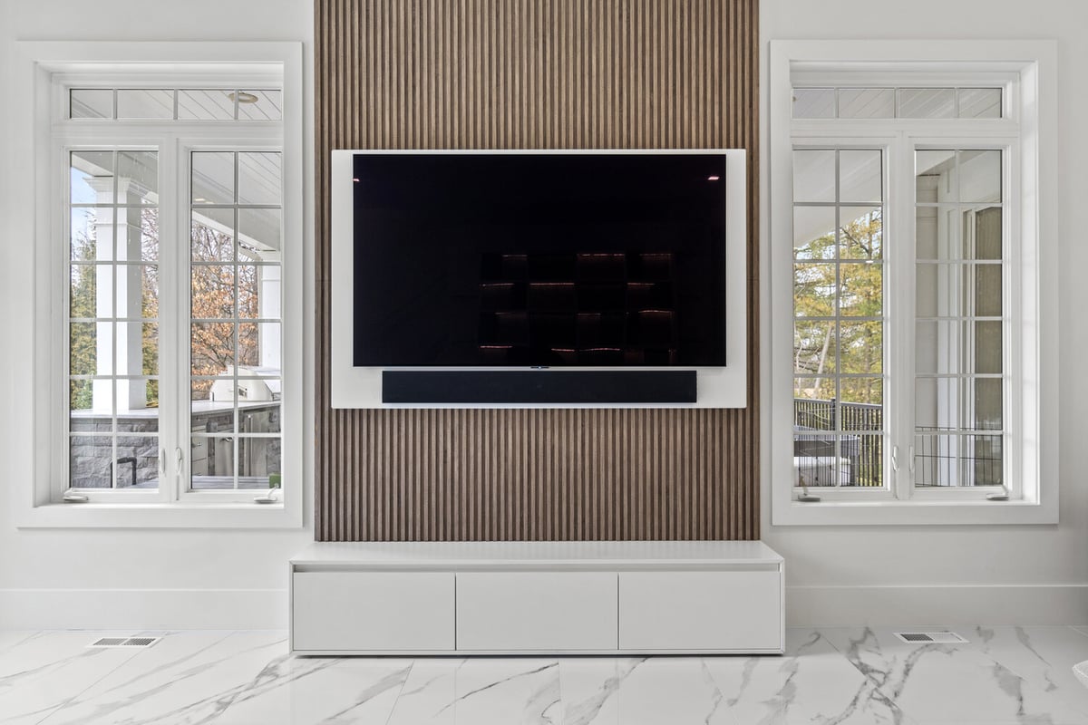 Wall-mounted TV with slatted wood accent wall in designlabs Northern Virginia remodel