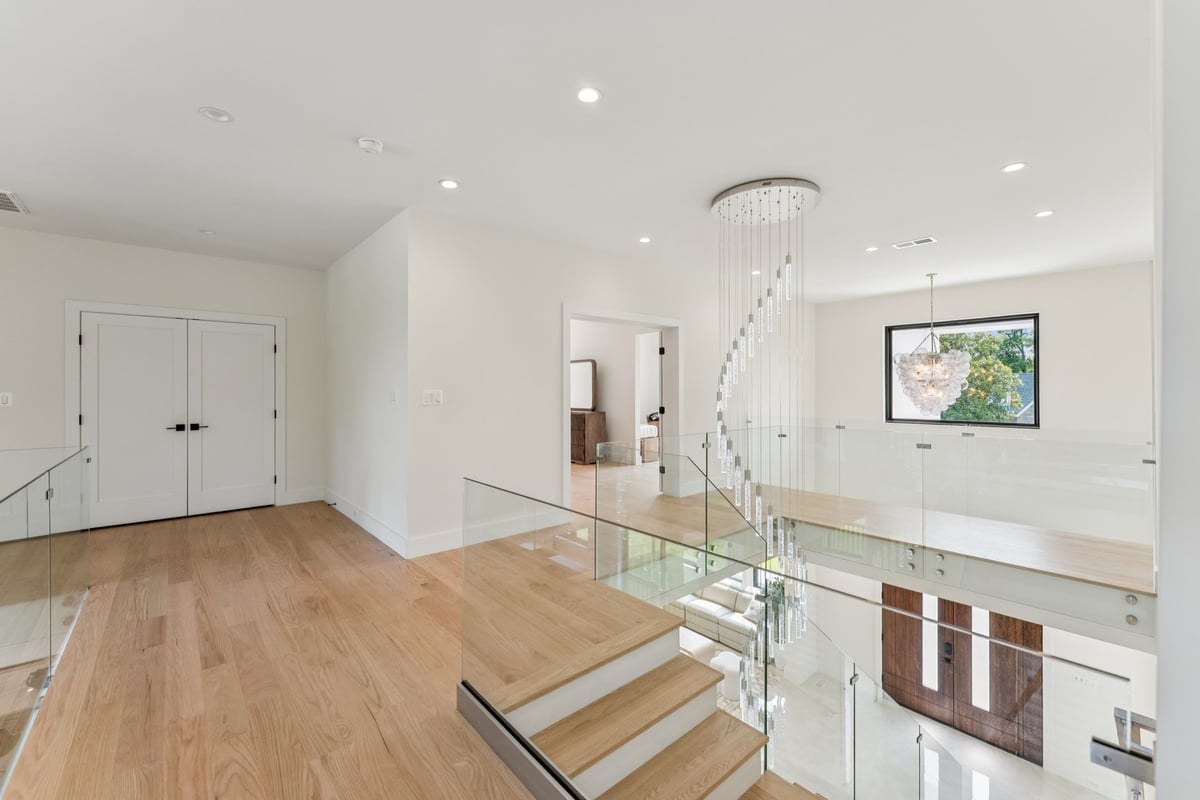 Bright hallway and staircase remodel with glass railing by DesignLab in Potomac