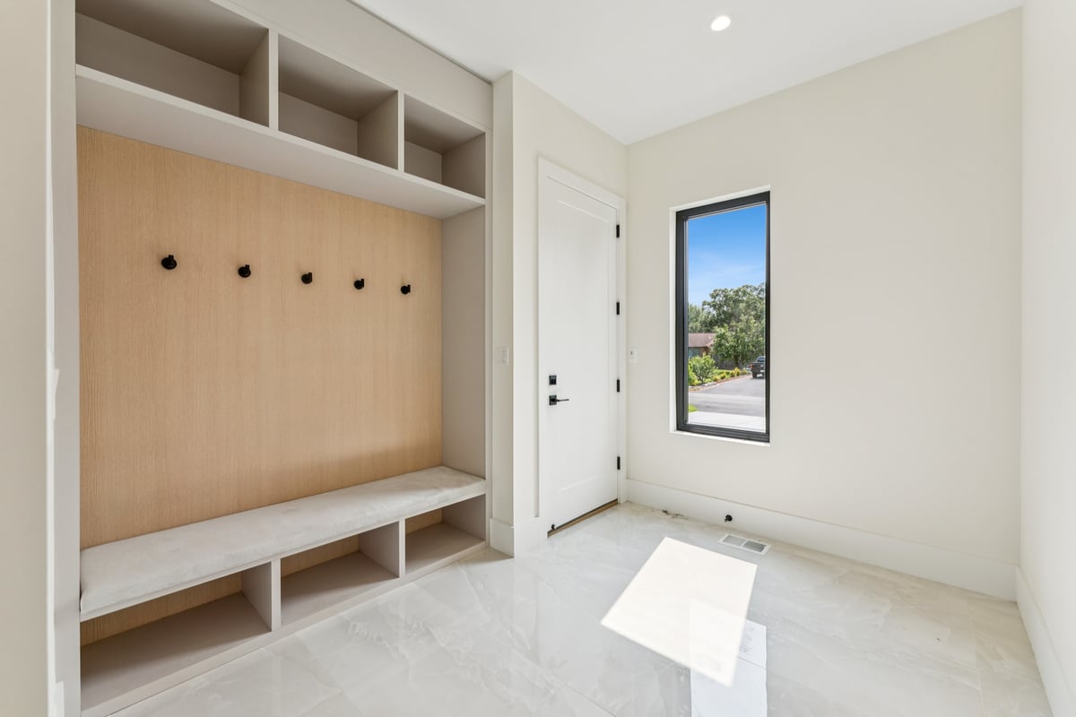 Bright mudroom entry with bench seating and storage in a custom home by DesignLab in Chevy Chase