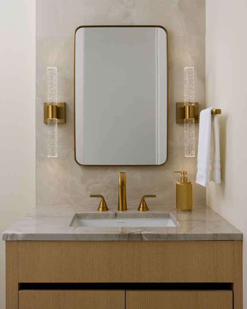Close-up of vanity and brass hardware in modern powder room by DesignLab in Metro Washington