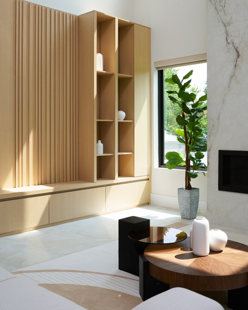 Close-up of vertical oak shelving and neutral seating in a DesignLab custom home in Metro Washington