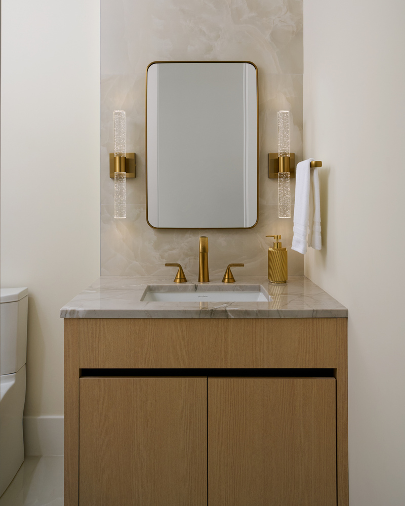 Compact bathroom design featuring wood cabinetry and designer lighting by DesignLab in Metro Washington