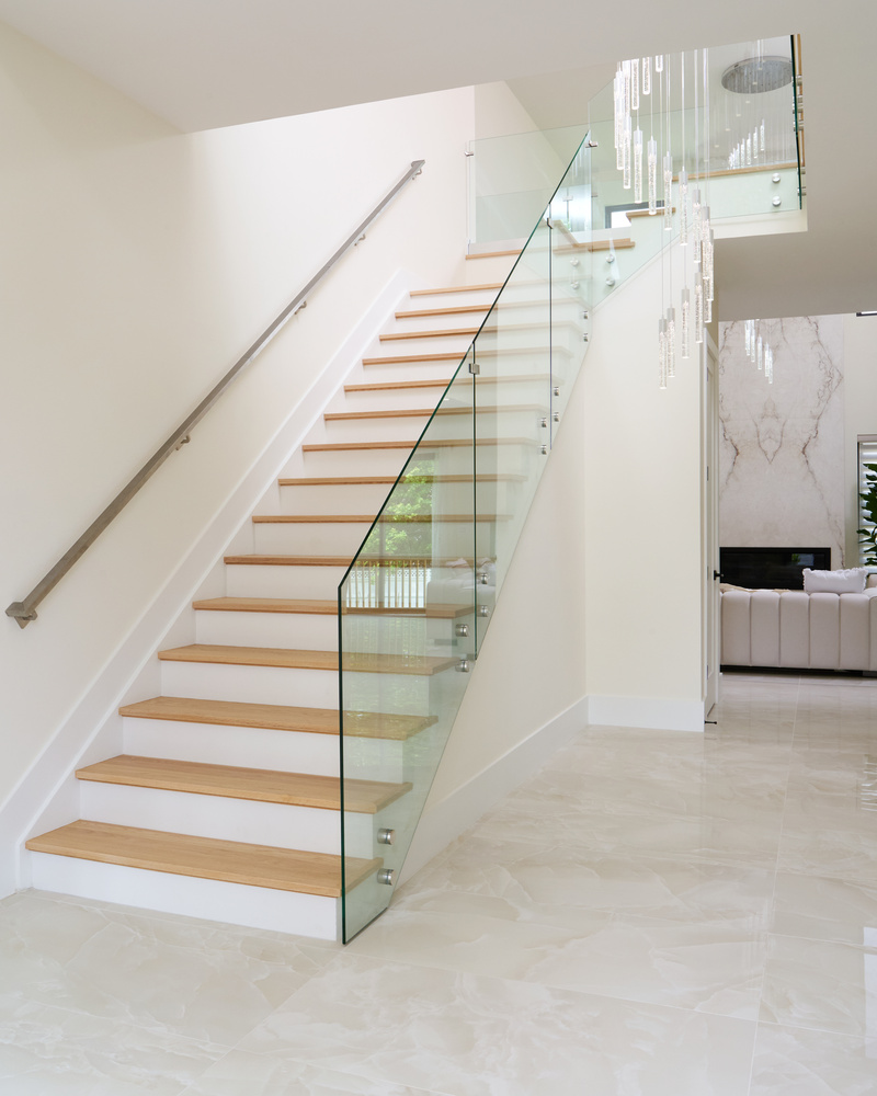 Floating staircase with glass railing in a contemporary custom home by DesignLab in Metro Washington