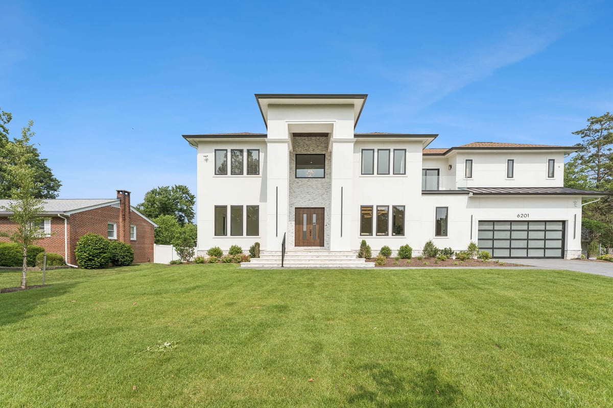 Grand modern house with stone entry and large windows by DesignLab serving McLean and Great Falls, VA