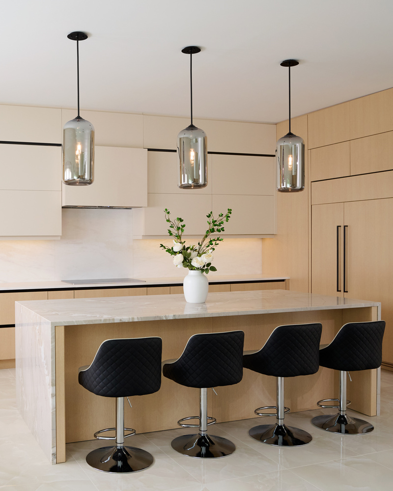Kitchen island with black stools and floral centerpiece by DesignLab in Metro Washington custom home