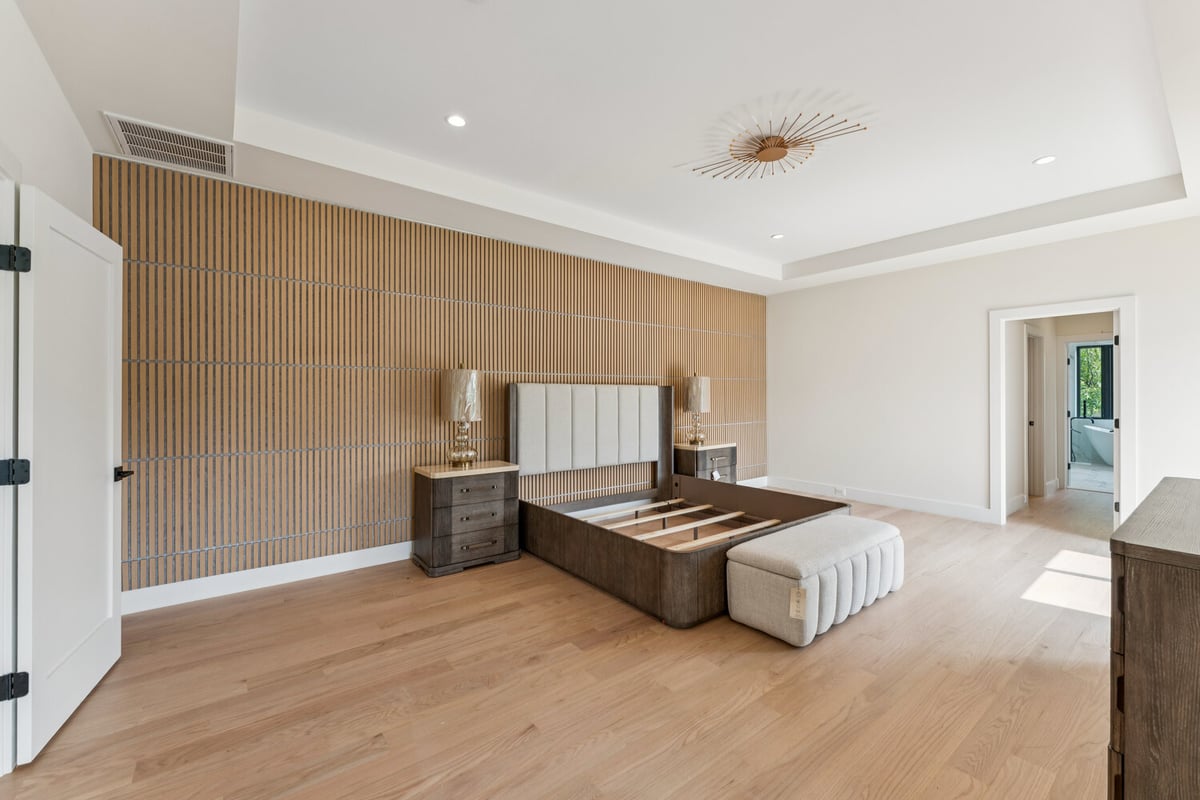 Luxury bedroom with custom wood accent wall and modern decor by DesignLab in Great Falls