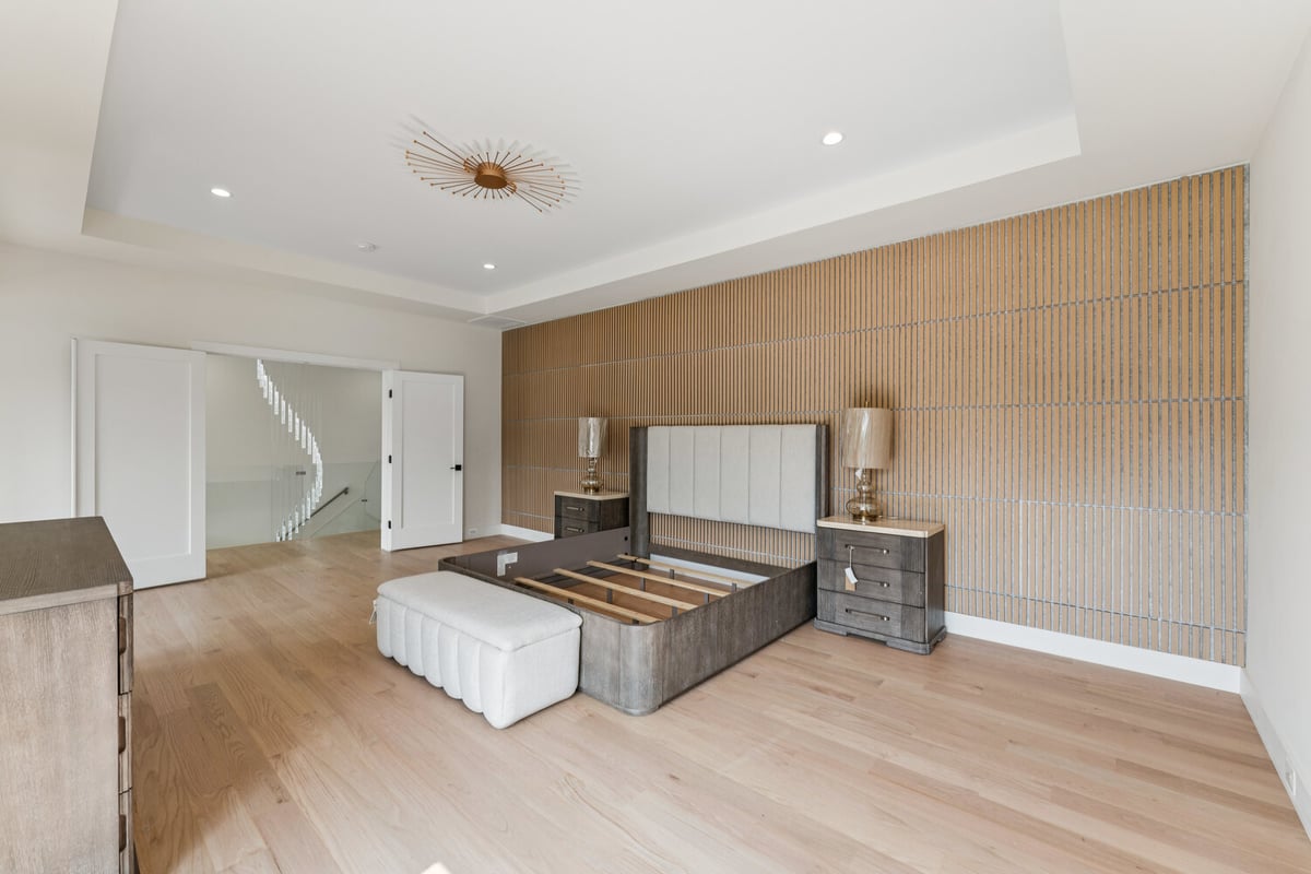Modern master bedroom renovation by DesignLab in Washington, DC featuring wood accent wall and contemporary lighting