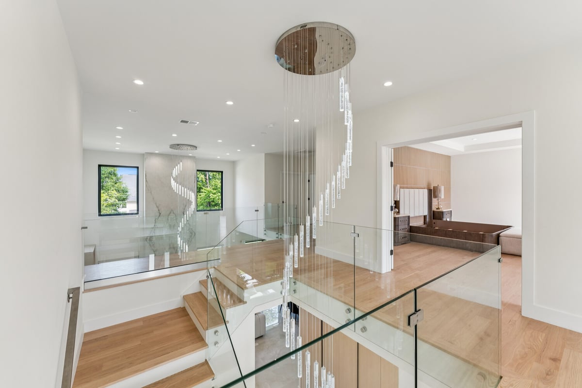 Open concept landing with stylish glass banister by DesignLab in Kalorama