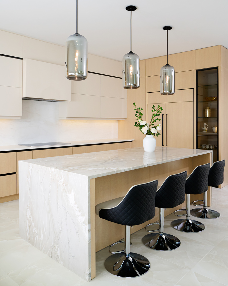 Quartz waterfall island and pendant lights in a DesignLab kitchen in Metro Washington