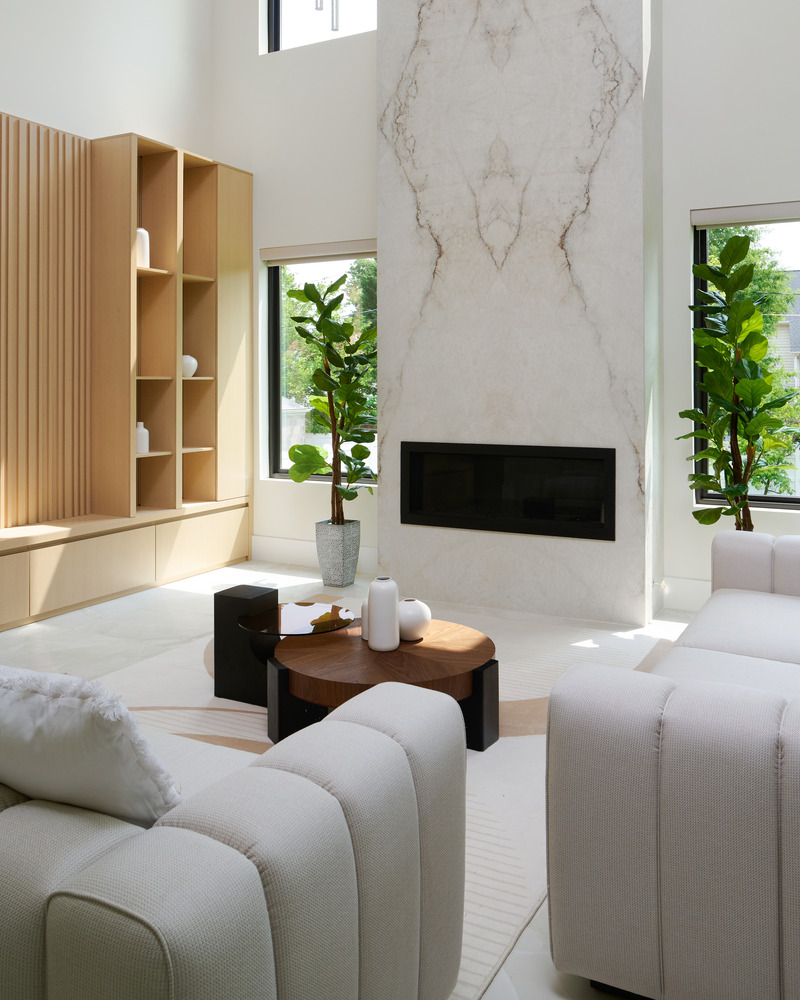 Stylish fireplace wall with surrounding built-ins in a Metro Washington custom home by DesignLab