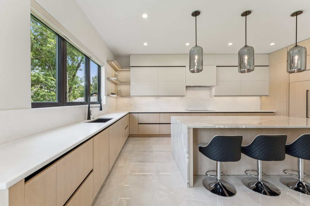 Stylish marble island and black stools in a kitchen remodel by DesignLab, Arlington, Virginia